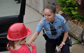 Police Officer gives a child a sticker.