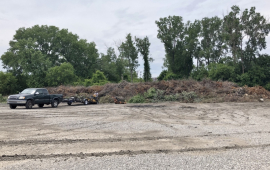 photo of truck next to large open brush pile at brush site