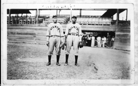 Two black men in Giants baseball uniforms on a baseball field